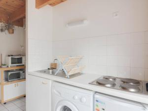 a kitchen with a washing machine and a sink at Maison Luz-Saint-Sauveur, 3 pièces, 4 personnes - FR-1-402-40 in Luz-Saint-Sauveur