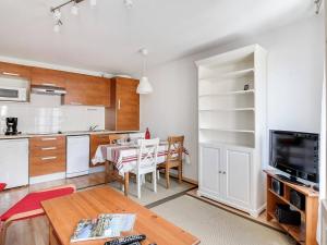 a kitchen and dining room with a table and a room with a kitchen at Charmant T2 en Centre-Ville pour 6 pers., Parking, Proche Commodités et Stations de Ski - FR-1-402-75 in Luz-Saint-Sauveur +4 photos