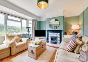 a living room with a couch and a fireplace at Llety Heulog in Dolgellau