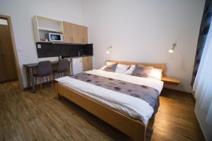 a bedroom with a bed and a table and a microwave at Apartmany 21 Třeboň in Třeboň