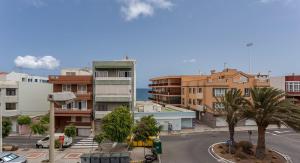 a view of a street in a city with buildings at Cute Apartment in Salinetas Beach. in Salinetas