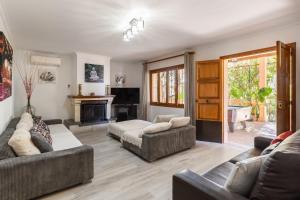 sala de estar con 2 sofás y chimenea en Finca Can Lluc en Alaró