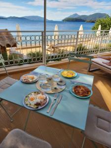 uma mesa com pratos de comida numa varanda em Greek Beach House B2 Lefkada em Nydri