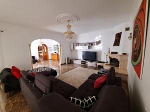 un soggiorno con un divano e una televisione di Villa Ramos ad Albufeira