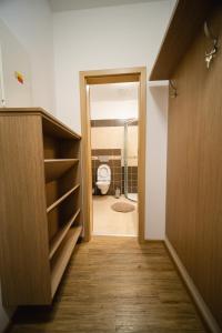 a bathroom with a door open to a toilet at Apartmany 21 Třeboň in Třeboň