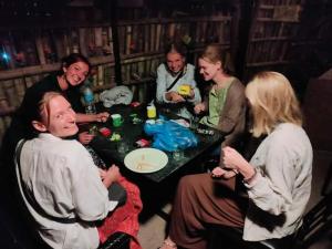 a group of people sitting around a table at Hostel Swastik in Bhaktapur