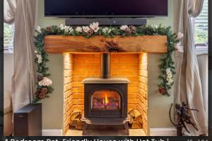 a fireplace with a television on top of it at Home in the Vale Of Evesham in Pershore