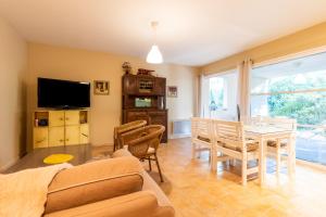 a living room with a table and a dining room at Appartement Lac de Lacanau in Lacanau