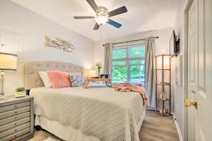 a bedroom with a bed and a ceiling fan at Darling Cottage about 1 Mi to Lake Erie Beach! in North East