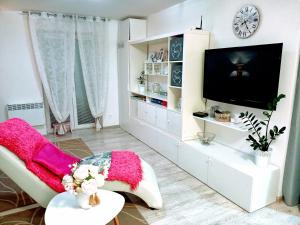 a living room with a tv and a white cabinet at Apartmán Romanna in Terchová