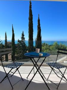 a blue table and two chairs on a patio at Il Mare di Giù Boutique Guesthouse in Licata