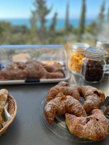 a table with a plate of pastries on a table at Il Mare di Giù Boutique Guesthouse in Licata