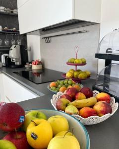 a kitchen with three bowls of fruit on a counter at Il Mare di Giù Boutique Guesthouse in Licata