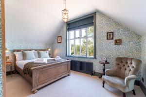 a bedroom with a bed and a window and a chair at The Beacon in Whitby