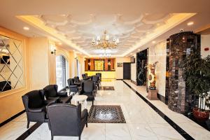 a waiting room with black chairs and a chandelier at Istanbul My Assos Hotel in Istanbul