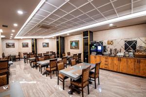 a restaurant with tables and chairs and a counter at Istanbul My Assos Hotel in Istanbul