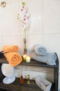 a bathroom with towels and a vase with a flower at CASA ROSY in Puerto del Rosario