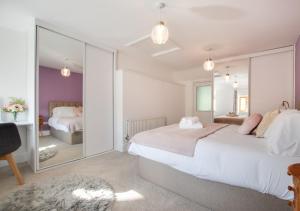 a bedroom with two beds and a large mirror at Hafod Gau in Cemmaes