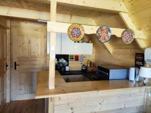 a kitchen in a log cabin with plates on the wall at Good Time in Sasino