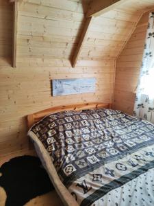 a bedroom with a bed in a log cabin at Good Time in Sasino +28 photos