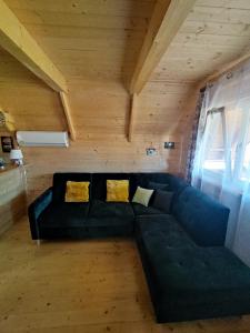 a living room with a blue couch in a attic at Good Time in Sasino