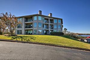 a large house on top of a grassy hill at Lakefront Hot Springs Condo with Pool Access! in Hot Springs