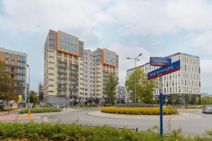 a street sign in front of some tall buildings at Warsaw Mokotów Apartments ABC by Renters in Warsaw