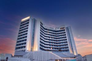 a large white building with lights on top of it at SL Hotel Gangneung in Gangneung
