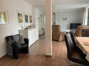 a living room with a table and chairs and a dining room at Little Cottage in Visselhövede