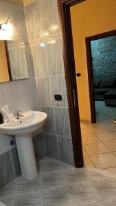 a bathroom with a sink and a shower at Casa di Paola in Asti