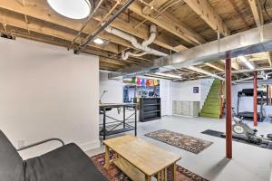 an industrial loft with white walls and wood ceilings at Cozy Studio Plus in Winooski with Home Gym! in Winooski