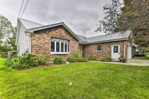 a brick house with a lawn in front of it at Cozy Studio Plus in Winooski with Home Gym! in Winooski