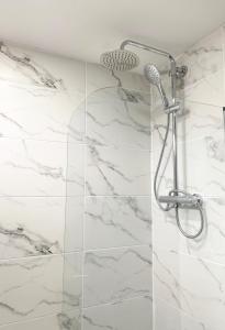 a white marble shower with a shower head at Pentland House - Lovely 2 bed flat in East Kilbride in East Kilbride