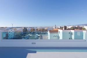 a view of a city from the balcony of a building at Las Afortunadas , Playa Arinaga 1ºA in Arinaga