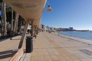 a bridge over a sidewalk next to the beach at Las Afortunadas , Playa Arinaga 1ºA in Arinaga