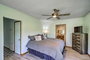 a bedroom with a bed and a ceiling fan at Cozy Norfork Home by White River Hike and Fish in Norfork