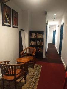 a hallway with a table and chairs and a book shelf at HOTEL SRI IMPIAN in Johor Bahru