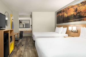 een hotelkamer met 2 bedden en een flatscreen-tv bij Days Inn by Wyndham Fulton in Fulton