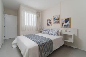 Кровать или кровати в номере Las Afortunadas - Playa Arinaga 1ºB