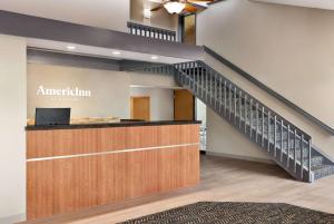 a stairway leading up to a lobby with a stair case at AmericInn by Wyndham Bemidji in Bemidji