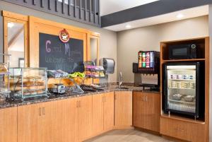 a restaurant kitchen with a counter with a refrigerator at AmericInn by Wyndham Bemidji in Bemidji +13 photos