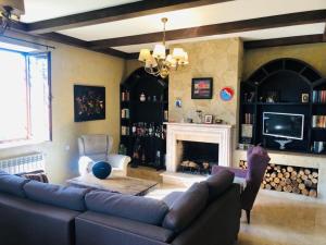 a living room with a couch and a fireplace at Cheerful 3-bedroom villa with pool in Oganavan