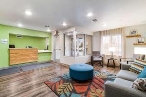 a living room with a couch and a table at WoodSpring Suites Harrisburg Linglestown in Harrisburg