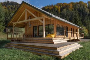 a large wooden house with a large deck at NaturparkResort Lausernest in Wildalpen