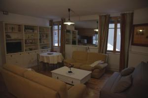 a living room with a couch and a table at Le Square in Bourg-Argental