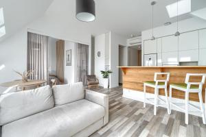 a living room with a couch and a kitchen at Aparthotel 1899 in Szczecin