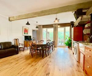 a kitchen and dining room with a table and chairs at Tree Tops Holiday Let & Sauna South Downs West Sussex Sleeps 10 in Hardham