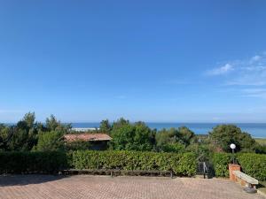 a bench in a park with the ocean in the background at Vigna Sul Mare in Marina Palmense