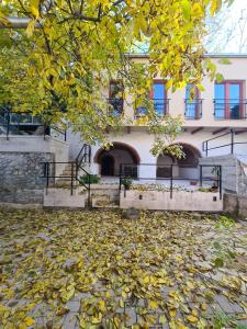 a building with a pile of leaves in front of it at Palantír Panzió in Miskolc