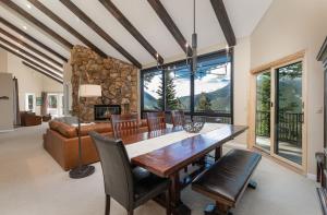 a dining room with a table and a couch at Cedar Upper Condominium 3 Bedroom condo in Estes Park